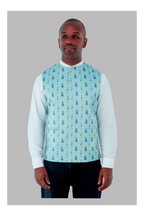 Man wearing a light blue patterned vest over a white long-sleeve shirt on a gray background