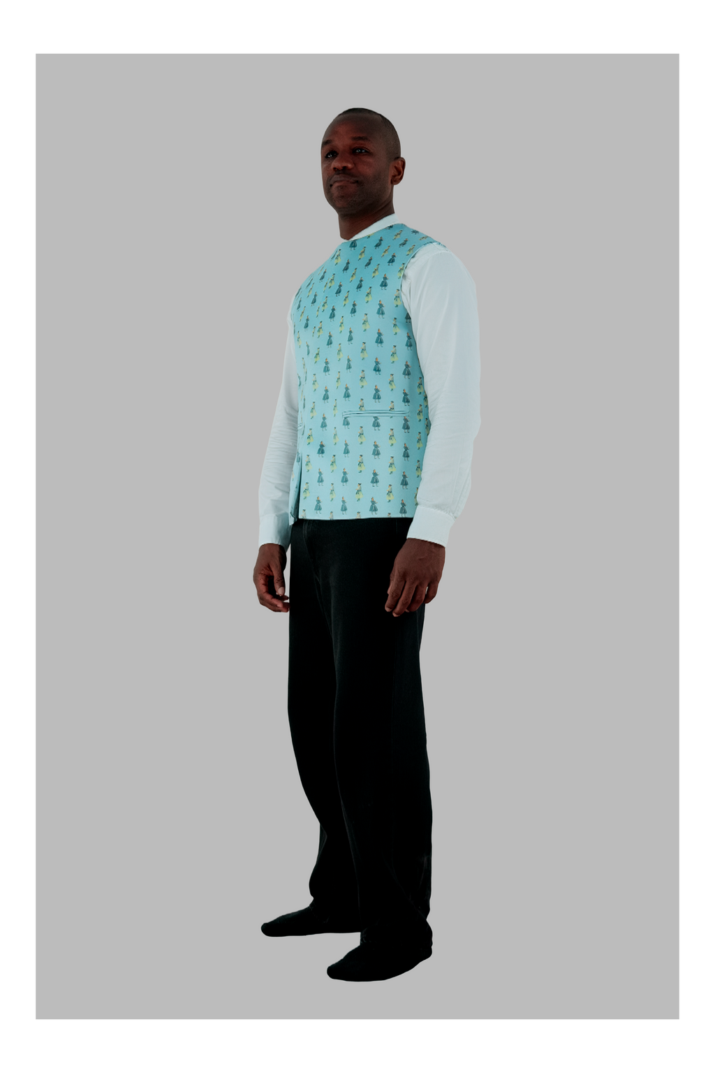 Man wearing a light blue patterned shirt with a white long-sleeve shirt underneath on a gray background
