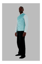 Man wearing a light blue patterned shirt with a white long-sleeve shirt underneath on a gray background