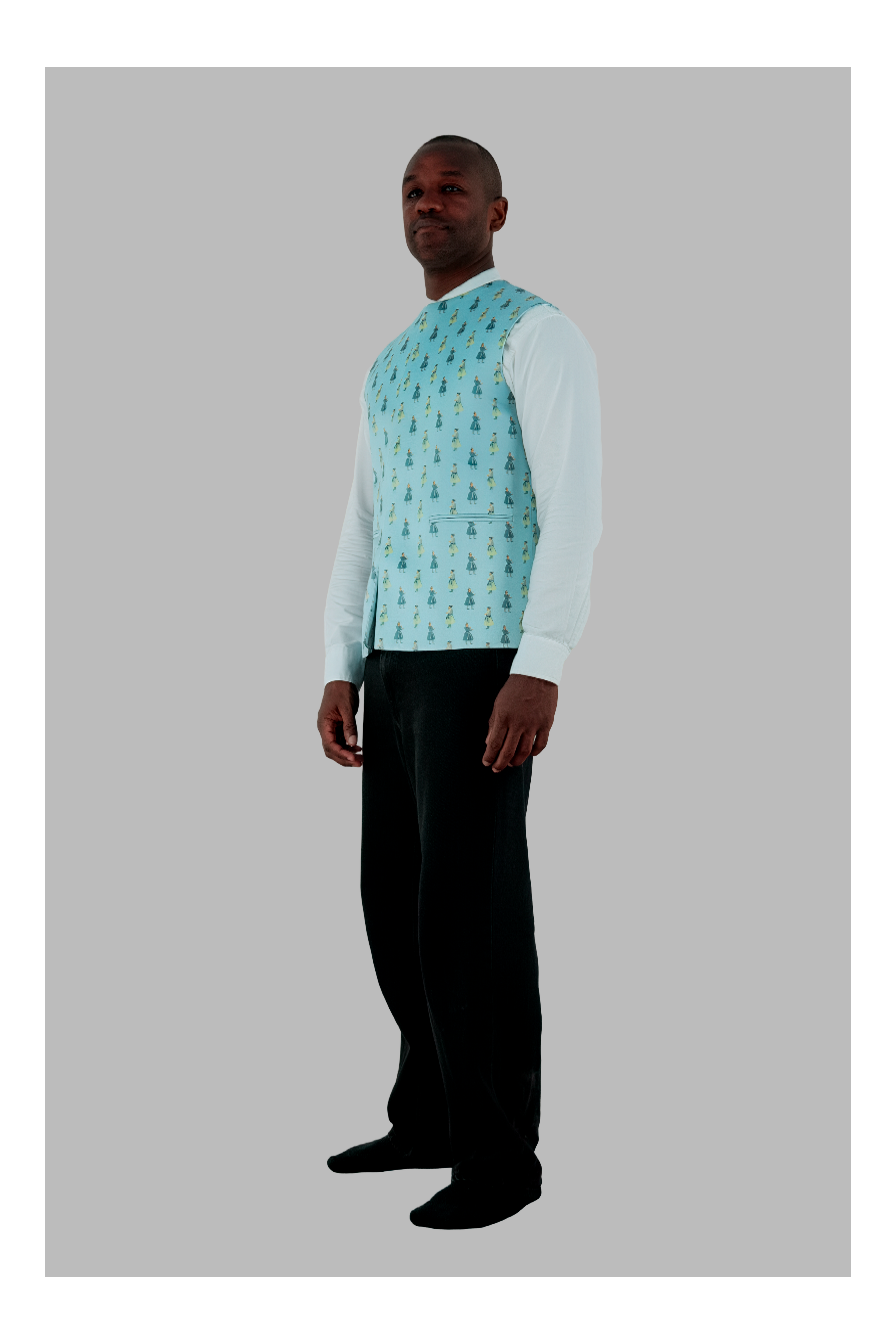 Man wearing a light blue patterned shirt with a white long-sleeve shirt underneath on a gray background