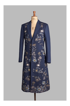 Navy blue coat with floral embroidery on a mannequin against a gray background