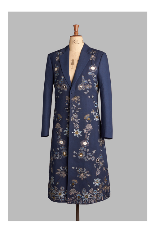 Navy blue coat with floral embroidery on a mannequin against a gray background