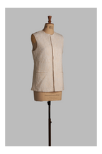 White vest on a mannequin against a gray background