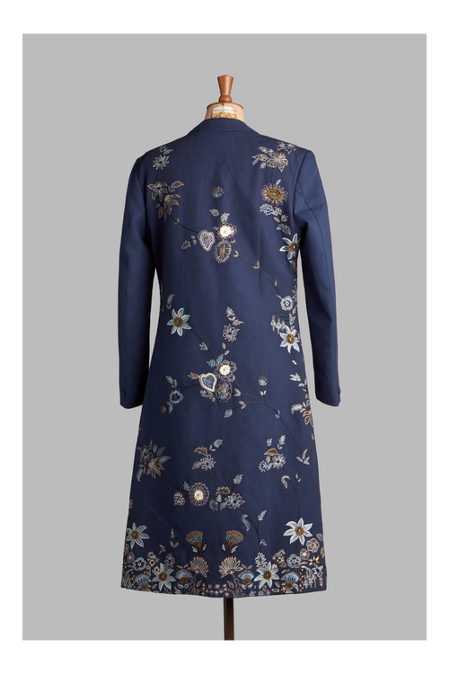 Navy blue long coat with floral embroidery on a mannequin against a gray background