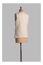 White vest on a mannequin against a gray background
