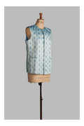 Light blue sleeveless jacket with printed pattern on a mannequin against a gray background