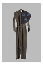 grey jumpsuit with belt and detachable collar accent on a grey background