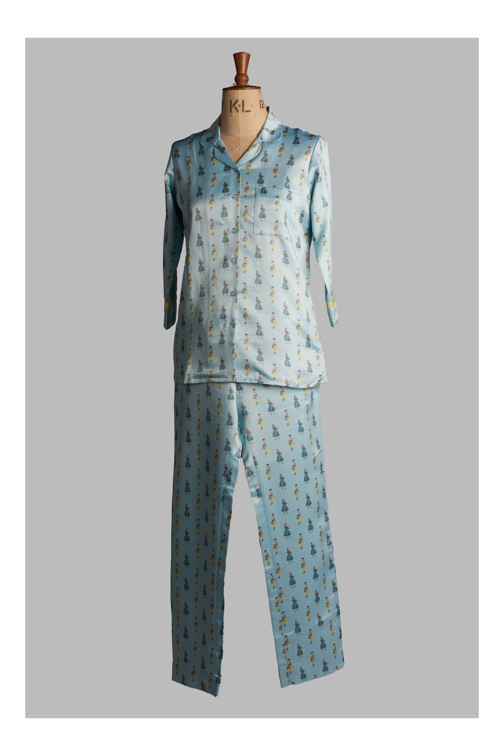 Light blue pajama set with a pattern on a mannequin against a gray background