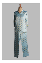 Light blue pajama set with a pattern on a mannequin against a gray background
